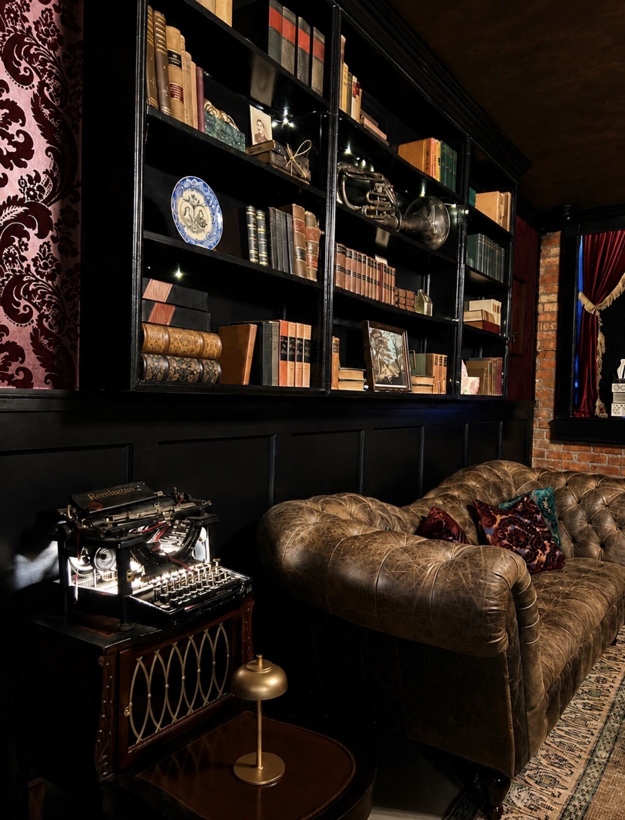 Leather chesterfield beneath the archive shelves